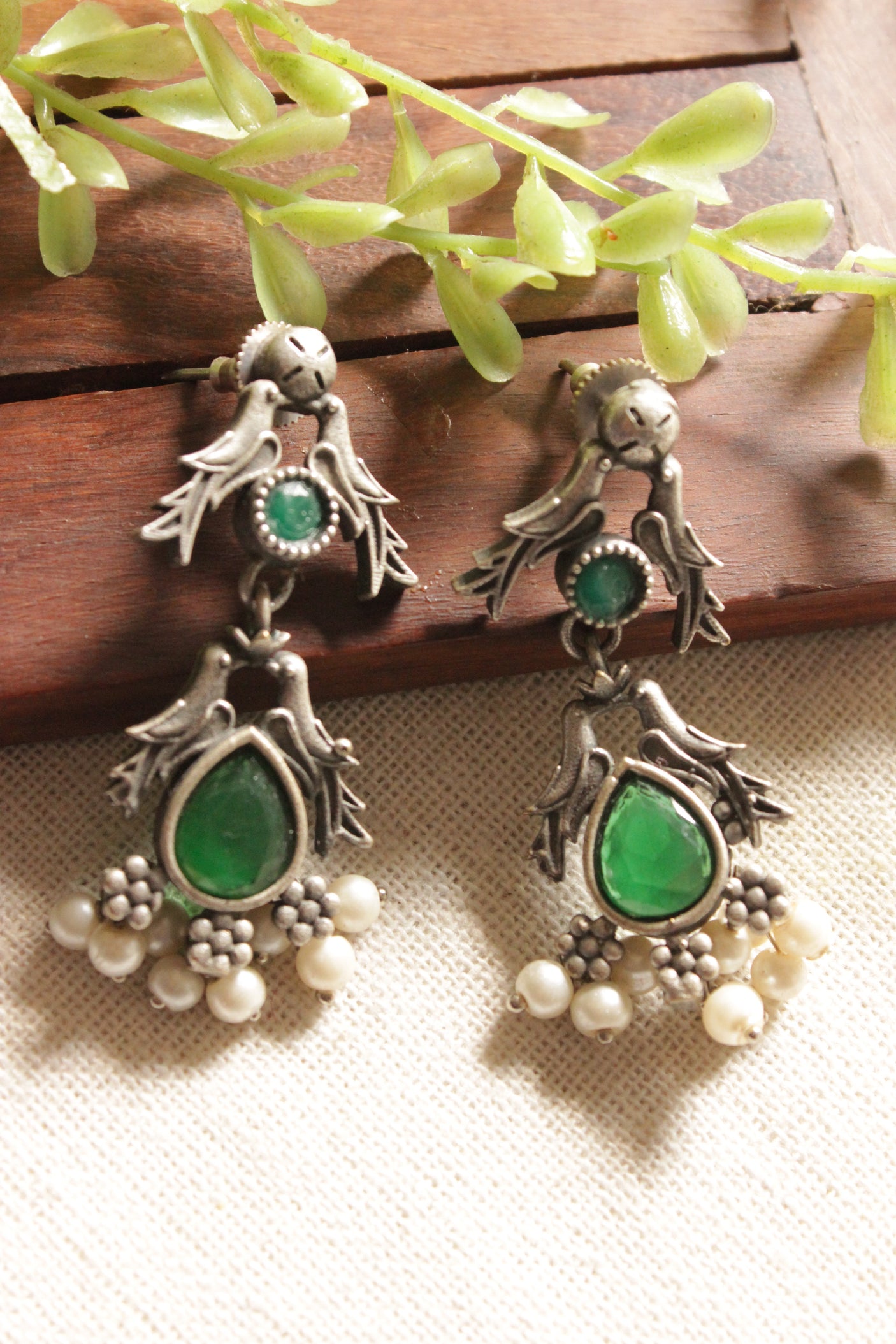 Premium Oxidised Finish Bird Motif Green Stones Embedded Earrings