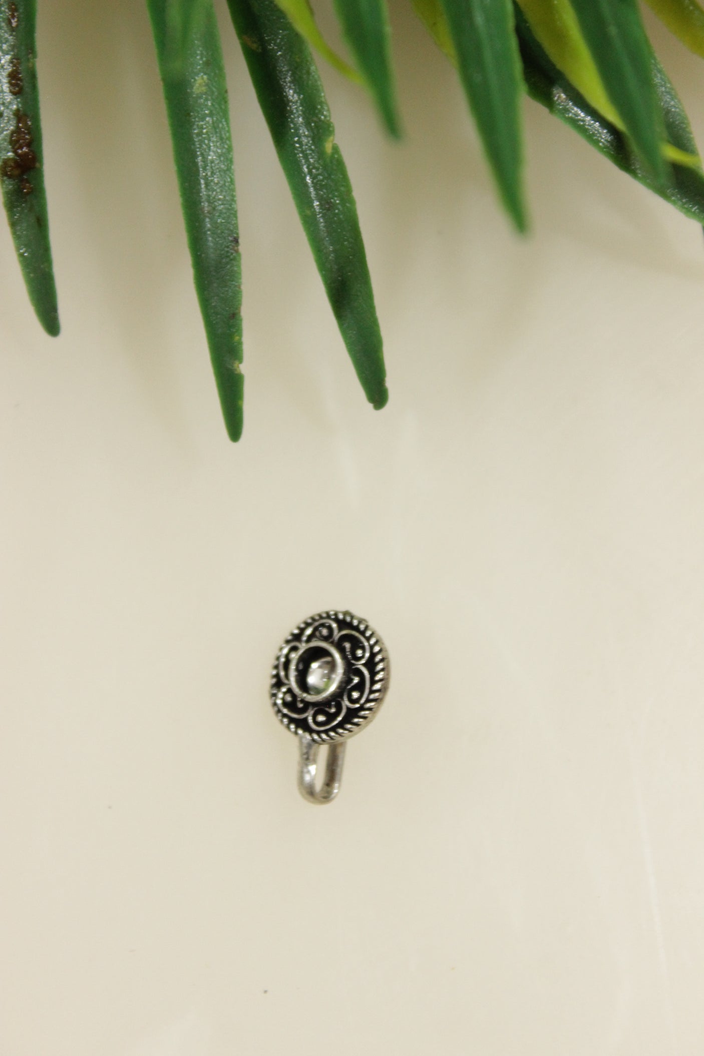 White Center Stone Embedded Flower Shape Oxidised Finish Clip On Nosepin