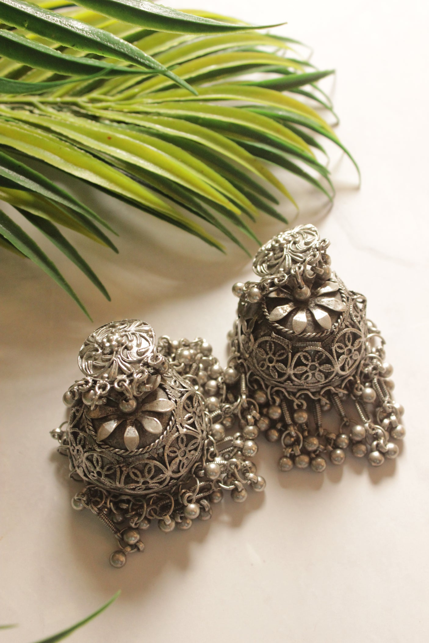 Flower Embossed Oxidised Finish Jhumka Earrings